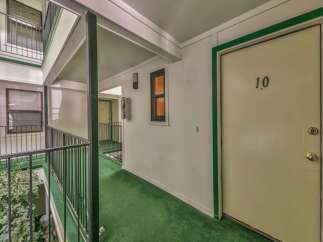 Discover this charming apartment complex with a welcoming outdoor walkway leading to unit 10.