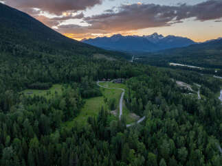 Discover this stunning mountain retreat, nestled amidst a vast, lush forest with breathtaking views of snow-capped peaks.