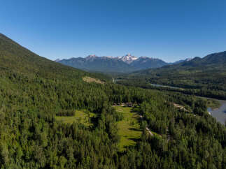 Discover this stunning property nestled amidst a lush, green forest with breathtaking mountain views.