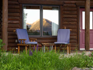 Experience the tranquility of mountain living with this charming log cabin.