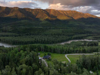 Experience breathtaking mountain views from this stunning property, nestled amidst a lush forest and overlooking a serene river.