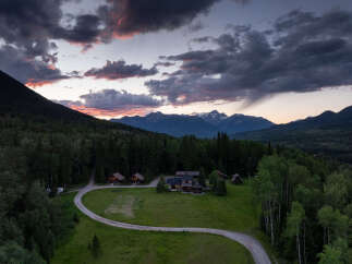 Experience the tranquility of this secluded mountain retreat, featuring multiple charming cabins nestled amidst a lush forest.
