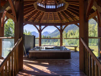 Experience ultimate relaxation in this stunning gazebo featuring a luxurious hot tub with breathtaking mountain views.