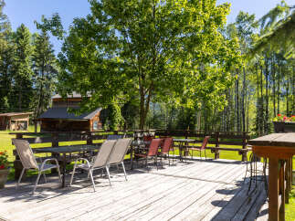 Enjoy outdoor dining and relaxation on this spacious wooden deck, perfect for entertaining guests or savoring peaceful moments.