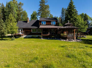 Experience serene living in this charming wooden home, nestled amidst lush greenery and mature trees.