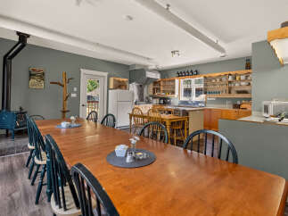 Gather your loved ones around this expansive wooden dining table, perfect for shared meals and memorable moments.