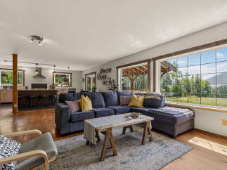 Experience breathtaking mountain views from this stunning living room, featuring a spacious sectional sofa perfect for gatherings.