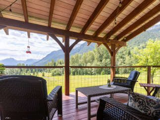 Enjoy breathtaking mountain views from this covered deck, perfect for relaxing or entertaining.