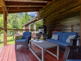 Enjoy outdoor living on this charming covered deck, perfect for entertaining or relaxing.