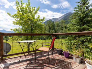 Enjoy breathtaking mountain views from this charming deck, perfect for morning coffee or evening relaxation.