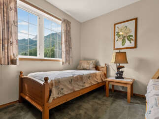 This charming bedroom features a cozy twin bed with a nature-inspired duvet cover, perfect for a restful night's sleep.