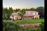 This expansive estate offers a luxurious Mediterranean-style residence with a sprawling lawn and mature trees, perfect for outdoor entertaining.