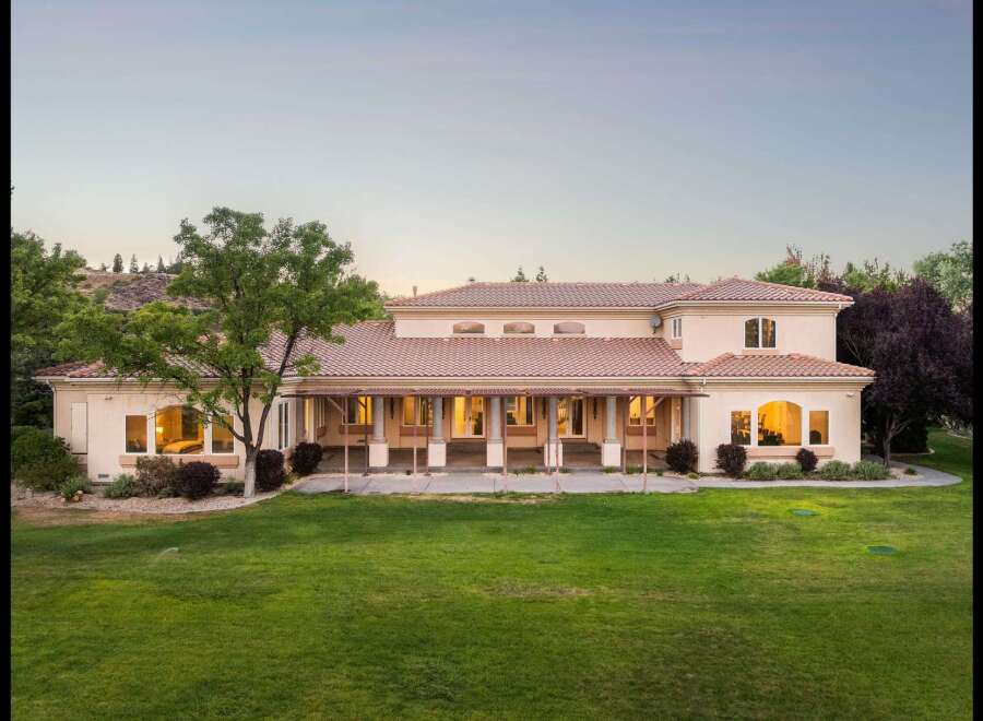 Experience luxury living in this expansive estate, featuring a sprawling backyard perfect for entertaining and relaxation.