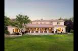 Experience luxury living in this expansive estate, featuring a sprawling backyard perfect for entertaining and relaxation.