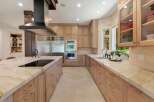 Experience luxury in this stunning chef's kitchen, featuring a large island with a built-in cooktop and ample seating.