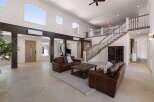 Experience luxury living in this grand foyer featuring a sweeping staircase and a dramatic two-story ceiling.
