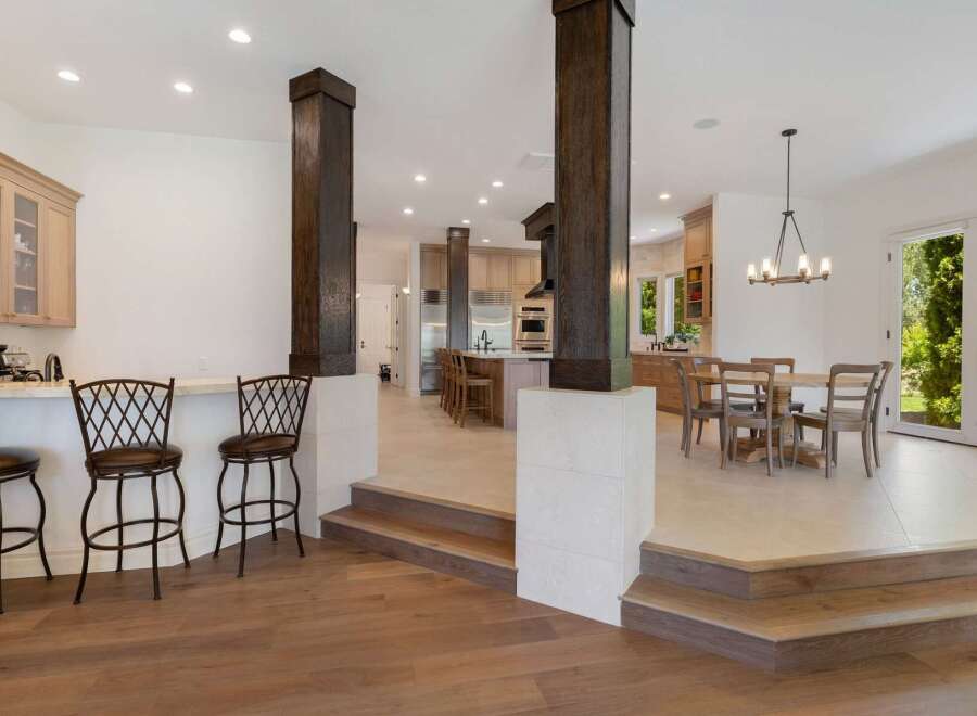Experience luxury living in this stunning open-concept home, featuring a gourmet kitchen with ample cabinet space and a spacious island perfect for entertaining.