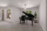 Experience elegance and musicality in this stunning room, featuring a grand piano as the centerpiece.
