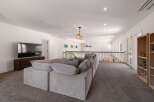 This spacious loft area offers a comfortable and inviting atmosphere, perfect for relaxation and entertainment.
