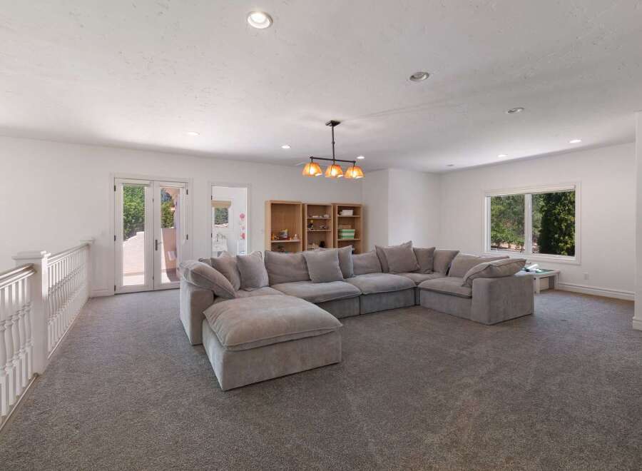 This spacious living area features a large, plush sectional sofa perfect for family gatherings or entertaining guests.