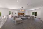 This spacious living area features a large, plush sectional sofa perfect for family gatherings or entertaining guests.