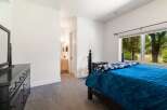 This bedroom offers a comfortable and stylish retreat, featuring a plush blue comforter and a decorative throw blanket.