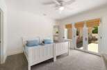 This charming bedroom features two twin beds with blue bedding, perfect for guests or children.