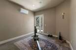 This home gym space features a rowing machine and weights, perfect for your fitness routine.