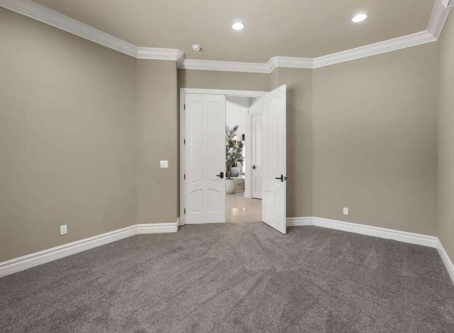 Step into this inviting room, featuring plush grey carpeting and elegant crown molding that adds a touch of sophistication.