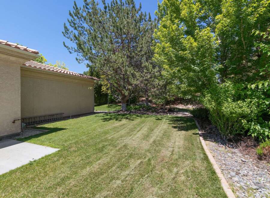 Enjoy the lush green backyard of this property, perfect for outdoor activities and relaxation.