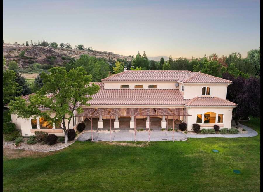 This expansive estate offers a luxurious lifestyle with its sprawling backyard and covered patio, perfect for outdoor entertaining.
