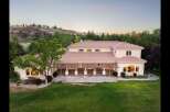 This expansive estate offers a luxurious lifestyle with its sprawling backyard and covered patio, perfect for outdoor entertaining.