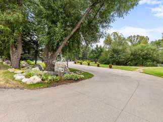 Welcome to this stunning property, marked by the elegant address number 1184, nestled amidst lush greenery and mature trees.