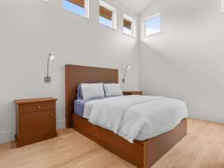 This modern bedroom features a sleek wooden platform bed with integrated storage, complemented by matching nightstands and a minimalist headboard.