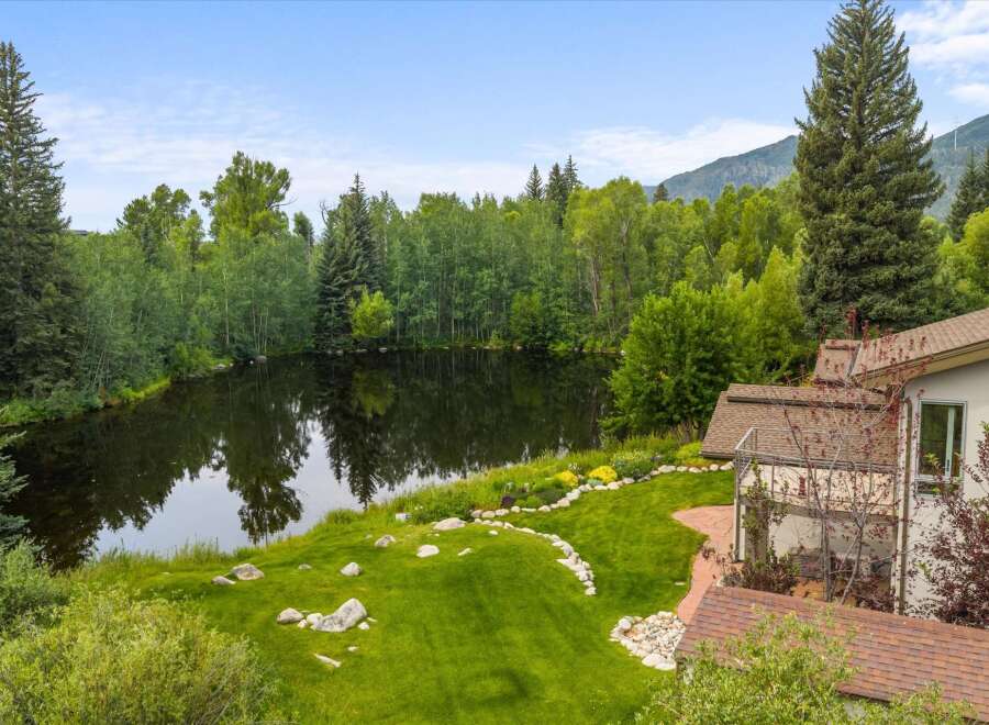Experience serene living with this stunning property featuring a private pond and lush greenery, perfect for tranquil moments.
