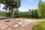 Enjoy serene lakefront living with this stunning property, featuring a spacious stone patio perfect for outdoor entertaining.