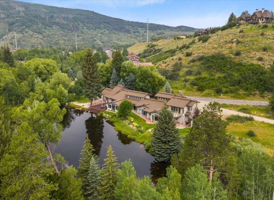 Nestled amidst lush greenery and a serene pond, this expansive property offers a unique blend of luxury and natural beauty.