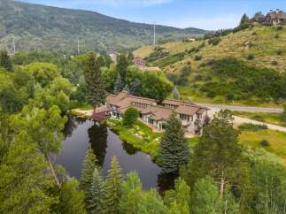 Nestled amidst lush greenery and a serene pond, this expansive property offers a unique blend of luxury and natural beauty.