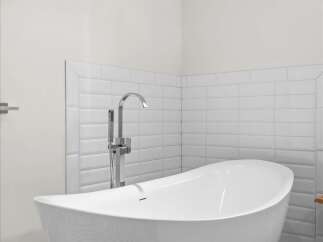 Experience modern luxury in this stunning bathroom, featuring a sleek freestanding bathtub as the centerpiece.