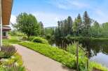 Discover serene living with this stunning property featuring a tranquil pond and lush landscaping.