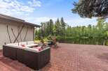 Enjoy serene waterfront living with this stunning property featuring a spacious patio overlooking a tranquil lake.