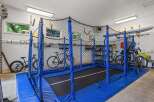 This spacious garage offers a dedicated recreational area with a large trampoline, perfect for family fun and exercise.