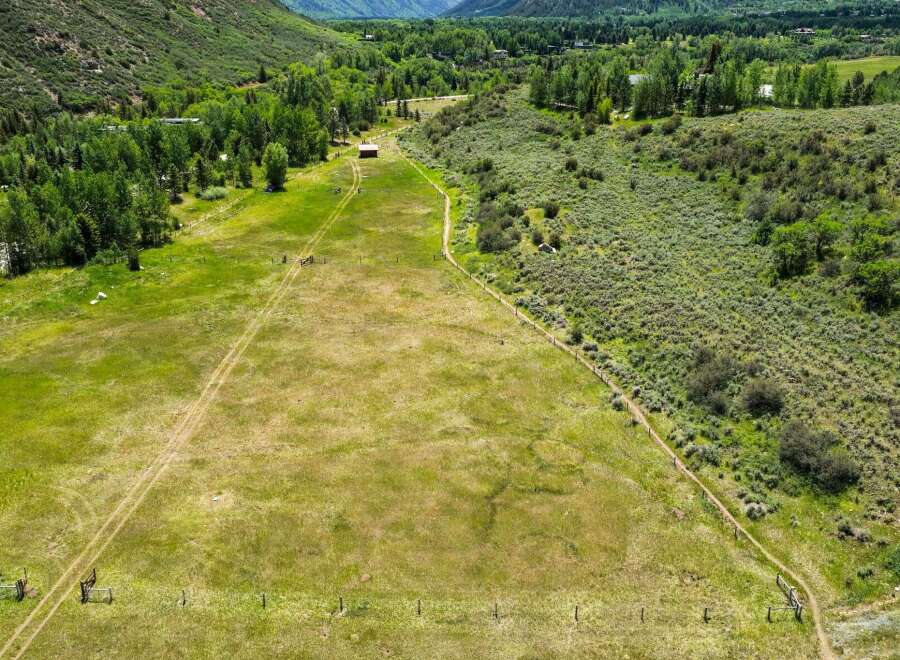 Discover this expansive property featuring rolling green pastures perfect for livestock or recreational activities.