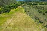 Discover this expansive property featuring rolling green pastures perfect for livestock or recreational activities.