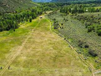 Discover this expansive property featuring rolling green pastures perfect for livestock or recreational activities.