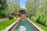 Experience luxury outdoor living with this stunning rectangular swimming pool, perfectly integrated into a lush, green backyard.