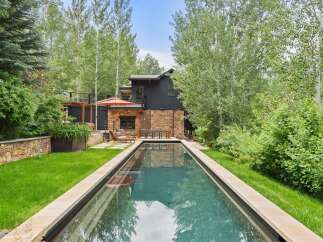 Experience luxury outdoor living with this stunning rectangular swimming pool, perfectly integrated into a lush, green backyard.