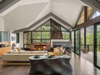 Experience luxurious mountain living in this stunning contemporary home, boasting soaring vaulted ceilings and expansive windows that frame breathtaking forest and mountain views.