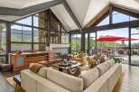 Experience luxury mountain living in this stunning home featuring a grand living area with soaring ceilings and a stone fireplace.
