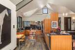 This spacious kitchen boasts modern stainless steel appliances and ample wooden cabinetry, perfect for any culinary enthusiast.